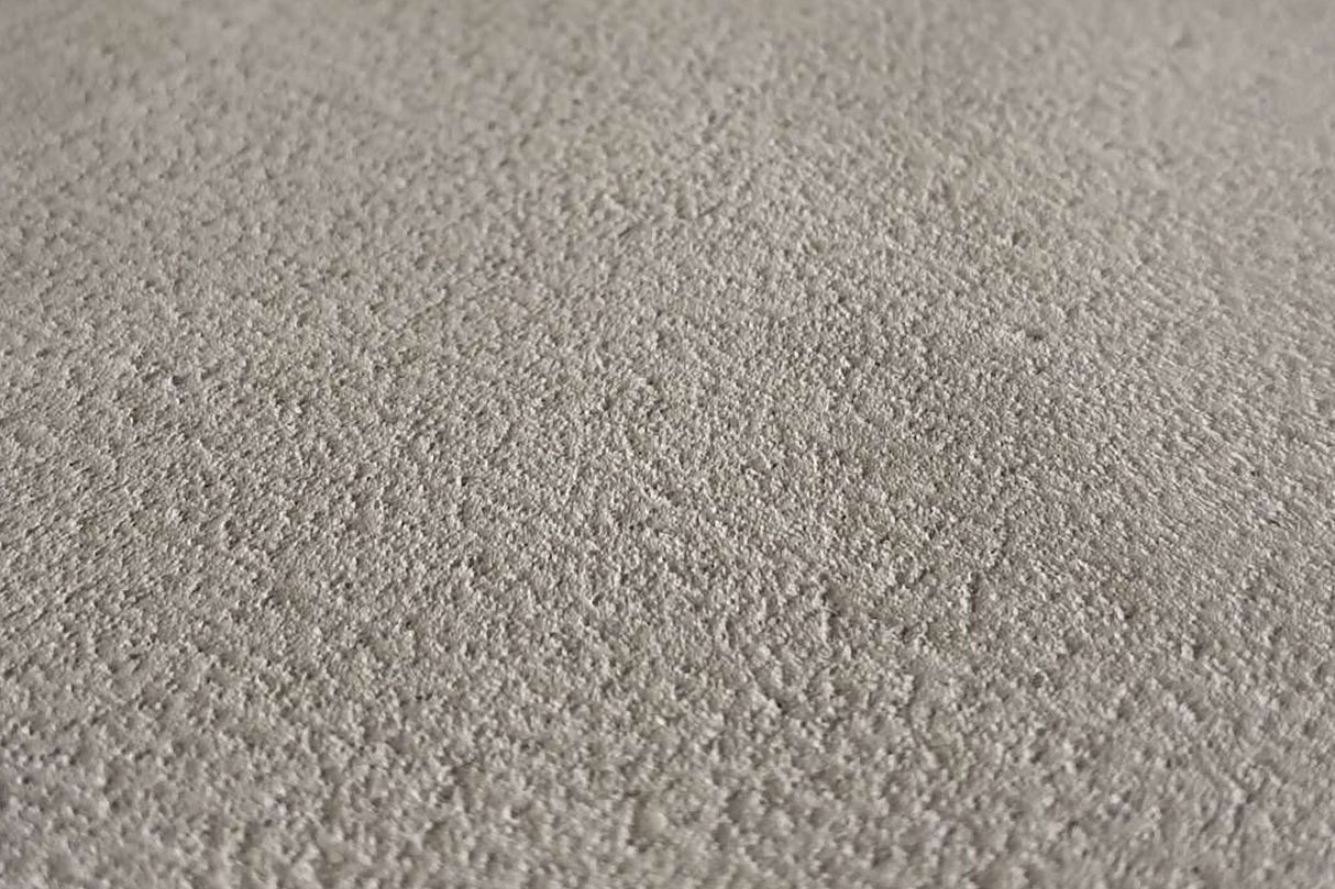 Beige strukturierte Wandoberfläche.