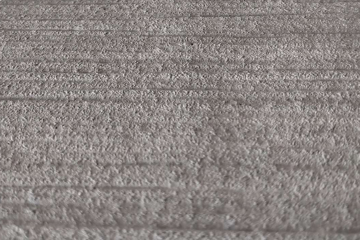 Graue, strukturierte Steinoberfläche.